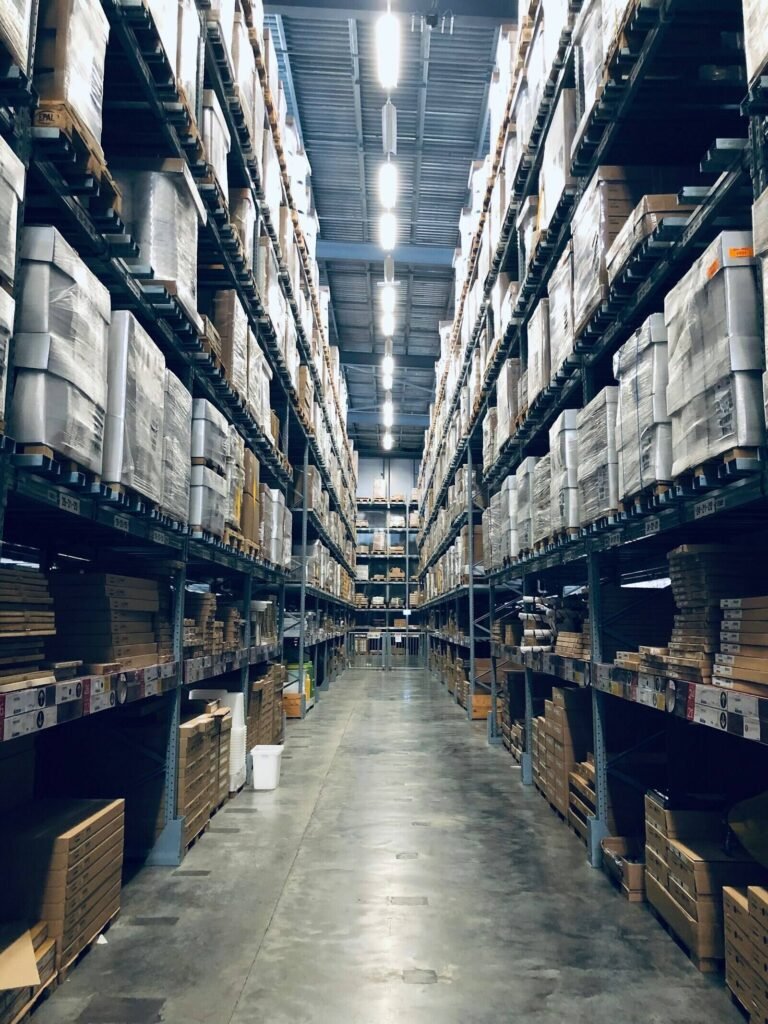 Rows of steel pallet racking stacked with palletised stock inside a warehouse